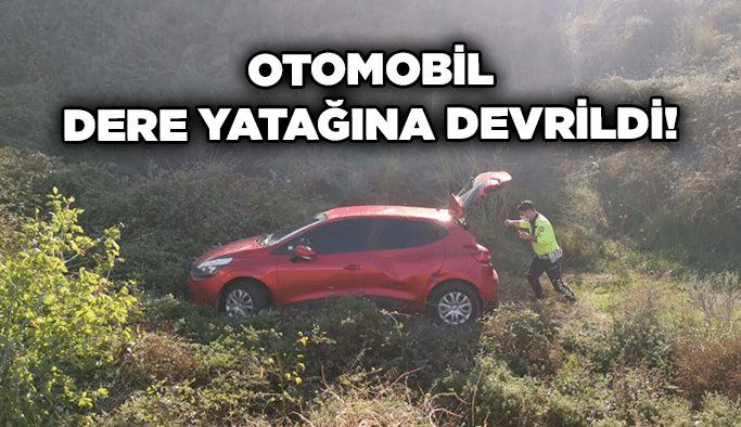 Otomobil dere yatağına devrildi!