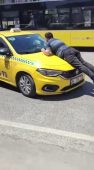 Pendik’te taksinin kaputuna çıkıp camı patlattı